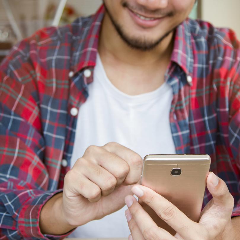 person looking at and touching cell phone